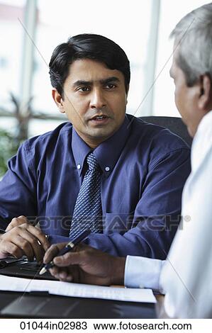 Indian business man talking to colleague View Large Photo Image Stock Image - Indian business man talking to colleague. Fotosearch