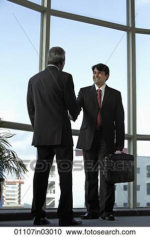 Indian business men shaking hands and smiling View Large Photo Image Stock Image - Indian business men shaking hands and smiling. Fotosearch