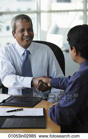 Indian business men shaking hands and smiling View Large Photo Image Stock Photography - Indian business men shaking hands and smiling. Fotosearch