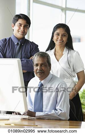 Indian business people smiling in front of computer. View Large Photo Image Stock Photography - Indian business people smiling in front of computer.. Fotosearch