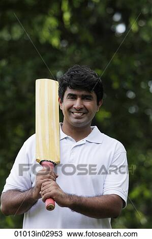 Indian man holding cricket bat View Large Photo Image Stock Image - Indian man holding cricket bat. Fotosearch