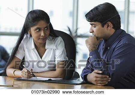 Indian woman and man discussing work View Large Photo Image Stock Image - Indian woman and man discussing work. Fotosearch