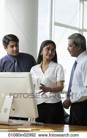 Indian woman discussing business with her male coleagues View Large Photo Image Stock Image - Indian woman discussing business with her male coleagues. Fotosearch