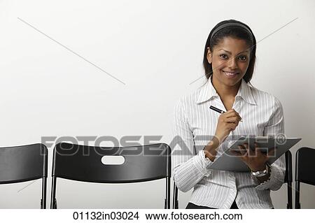 Indian woman fills our form in waiting room View Large Photo Image Picture - Indian woman fills our form in waiting room. Fotosearch