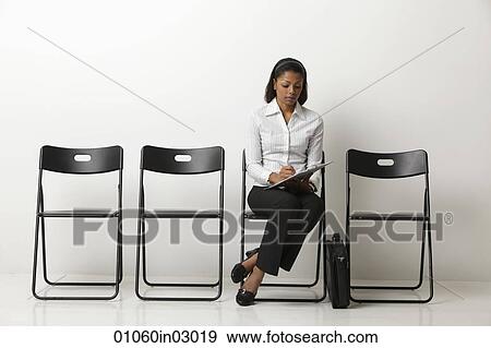 Indian woman fills out form and waits. View Large Photo Image Stock Photo - Indian woman fills out form and waits.. Fotosearch