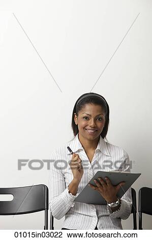 Indian woman holds clip board and smiles View Large Photo Image Stock Image - Indian woman holds clip board and smiles. Fotosearch