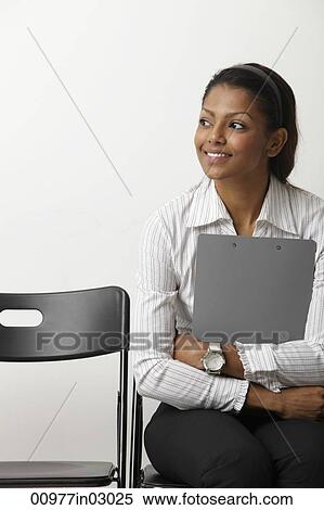 Indian woman holds clip board and smiles View Large Photo Image Stock Photography - Indian woman holds clip board and smiles. Fotosearch