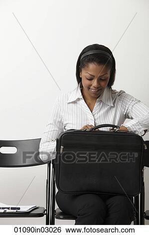 Indian woman looks into her brief case View Large Photo Image Stock Photograph - Indian woman looks into her brief case. Fotosearch