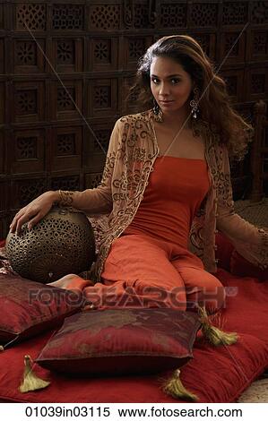 Indian woman sitting on pillows View Large Photo Image Stock Photography - Indian woman sitting on pillows. Fotosearch