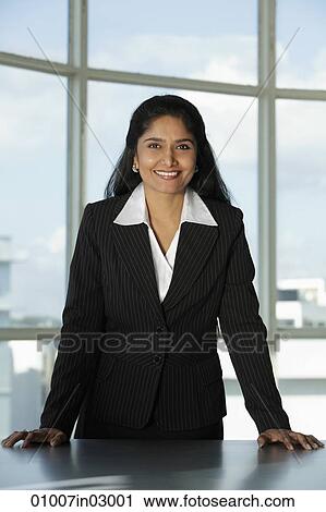 Indian woman standing at her desk View Large Photo Image Stock Image - Indian woman standing at her desk. Fotosearch