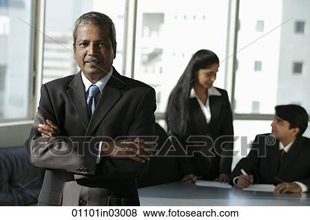 Mature Indian man standing in front of his colleages View Large Photo Image Stock Photo - Mature Indian man standing in front of his colleages. Fotosearch