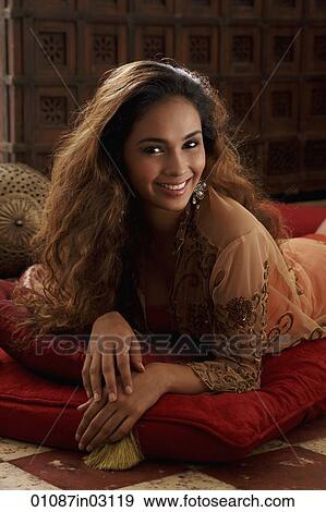 Stock Photo - Portrait of young Indian woman smiling at camera. Fotosearch