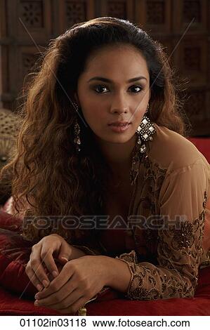 Portrait of young Indian woman wearing traditional earrings View Large Photo Image Stock Photo - Portrait of young Indian woman wearing traditional earrings. Fotosearch