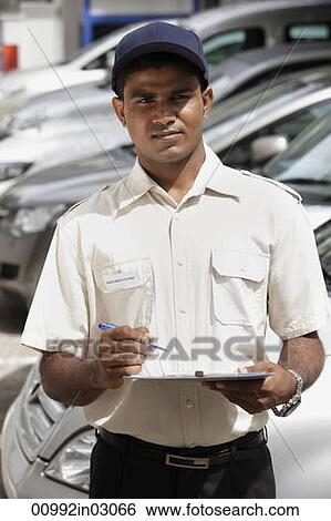 Security guard holding clipboard View Large Photo Image Stock Photograph - Security guard holding clipboard. Fotosearch