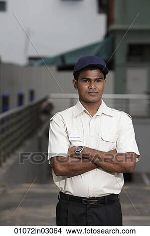 Security guard standing with arms folded View Large Photo Image Picture - Security guard standing with arms folded. Fotosearch