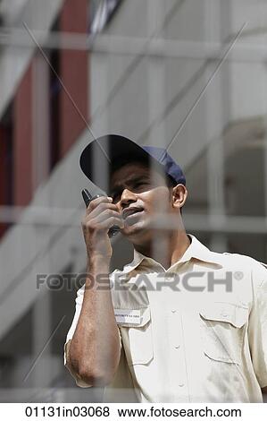 Security guard talking on walkie talkie View Large Photo Image Stock Photo - Security guard talking on walkie talkie. Fotosearch