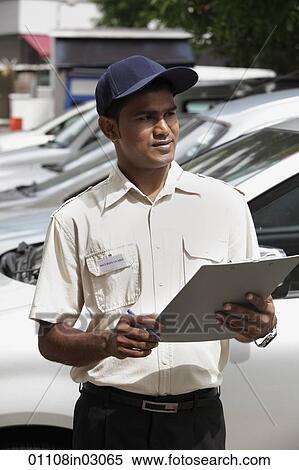 Stock Photography - Security guard writing on clipboard. Fotosearch