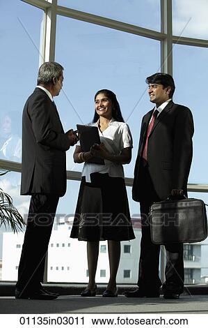 Three Indian people in business suits talking together View Large Photo Image Stock Image - Three Indian people in business suits talking together. Fotosearch