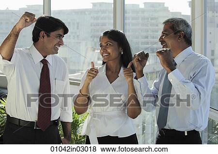 Three Indian people smiling at each other and making hand gestures View Large Photo Image Stock Photo - Three Indian people smiling at each other and making hand gestures. Fotosearch