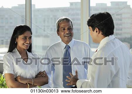 Three Indian people talking together and laughing View Large Photo Image Stock Image - Three Indian people talking together and laughing. Fotosearch