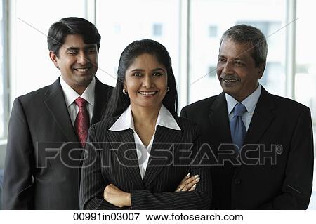 Two business men looking at their female colleague View Large Photo Image Stock Photo - Two business men looking at their female colleague. Fotosearch