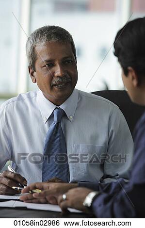 two business men talking to eachother View Large Photo Image Stock Photograph - two business men talking to eachother. Fotosearch