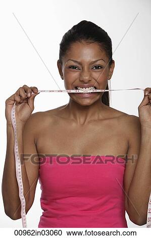 Woman biting tape measure View Large Photo Image Stock Image - Woman biting tape measure. Fotosearch