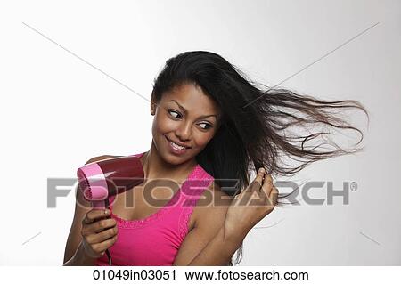 woman blow drying her long hair View Large Photo Image Stock Image - woman blow drying her long hair. Fotosearch