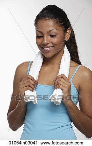 Woman holding towel around neck and smiling View Large Photo Image Stock Image - Woman holding towel around neck and smiling. Fotosearch