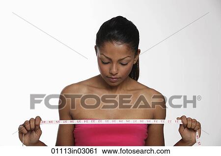 woman looking down at tape measure View Large Photo Image Stock Image - woman looking down at tape measure. Fotosearch