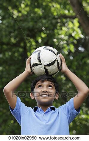 Young boy balances ball on his head View Large Photo Image Stock Image - Young boy balances ball on his head. Fotosearch