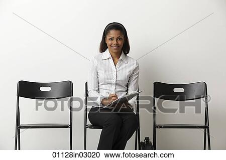 Young Indian woman fills out form and waits in waiting room View Large Photo Image Stock Image - Young Indian woman fills out form and waits in waiting room. Fotosearch