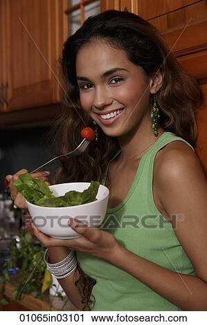 Young woman eating salad and smiling View Large Photo Image Stock Image - Young woman eating salad and smiling. Fotosearch