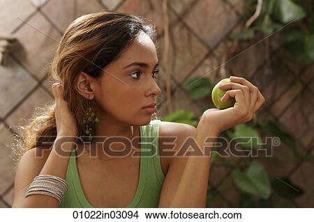 Young woman holding green apple View Large Photo Image Picture - Young woman holding green apple. Fotosearch