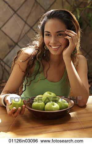 Young woman with a bowl of green apples smiling View Large Photo Image Stock Photograph - Young woman with a bowl of green apples smiling. Fotosearch