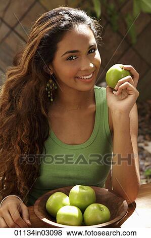 Young woman with bowl of green apples smiling View Large Photo Image Stock Photo - Young woman with bowl of green apples smiling. Fotosearch