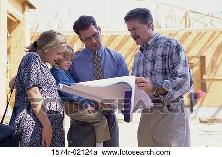 Architect discussing blueprints with a family View Large Photo Image Stock Image - Architect discussing blueprints with a family. Fotosearch