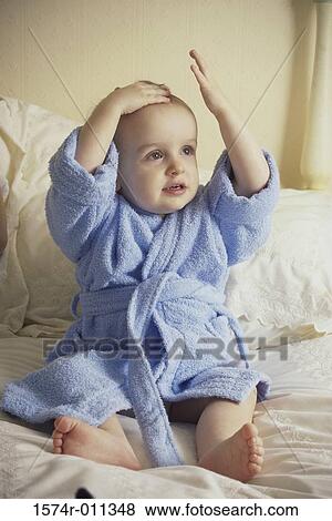 Stock Photo - Baby boy wearing a blue bathrobe. Fotosearch