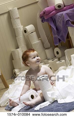 Picture - Baby playing with toilet paper rolls. Fotosearch