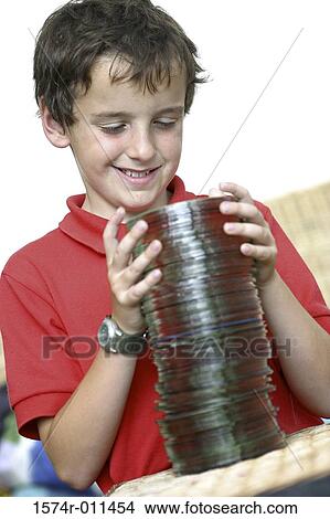 Boy holding a stack of CD's View Large Photo Image Picture - Boy holding a stack of CD's. Fotosearch