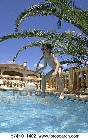 Boy jumping into a swimming pool View Large Photo Image Stock Image - Boy jumping into a swimming pool. Fotosearch