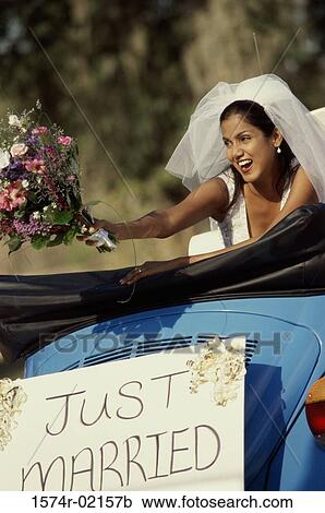 Bride preparing to toss a bouquet of flowers from a convertible car View Large Photo Image Stock Image - Bride preparing to toss a bouquet of flowers from a convertible car. Fotosearch
