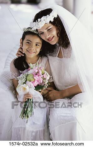 Bride smiling with a flower girl View Large Photo Image Stock Image - Bride smiling with a flower girl. Fotosearch