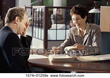 Businessman and a businesswoman having a discussion View Large Photo Image Stock Image - Businessman and a businesswoman having a discussion. Fotosearch