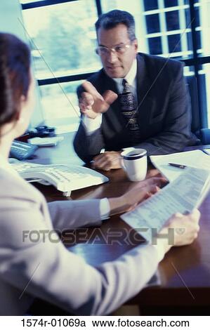 Businessman and a businesswoman in a meeting View Large Photo Image Stock Image - Businessman and a businesswoman in a meeting. Fotosearch