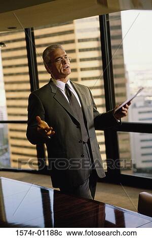 Stock Image - Businessman holding a file. Fotosearch