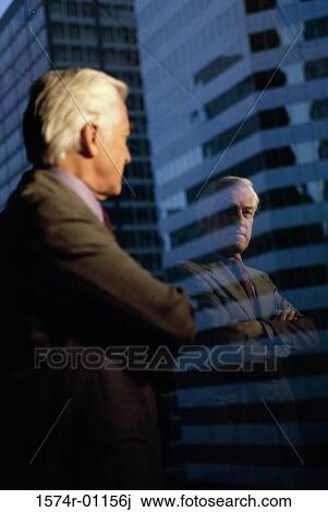 Businessman looking out of a window View Large Photo Image Stock Image - Businessman looking out of a window. Fotosearch