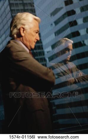 Businessman looking out of a window View Large Photo Image Stock Image - Businessman looking out of a window. Fotosearch