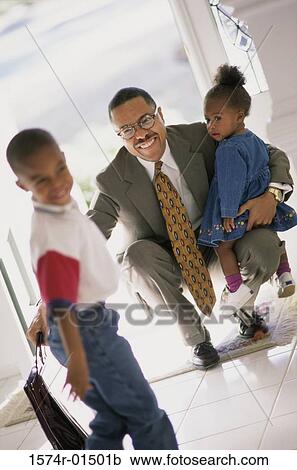 Businessman meeting his son and daughter at the door View Large Photo Image Stock Image - Businessman meeting his son and daughter at the door. Fotosearch