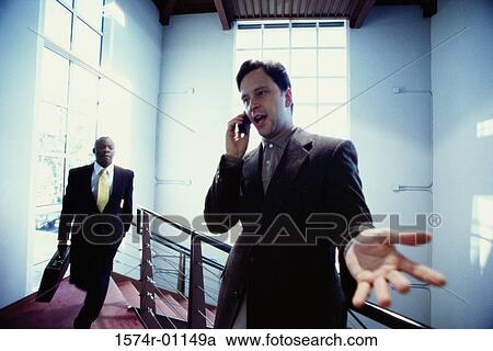 Stock Image - Businessman talking on a mobile phone. Fotosearch
